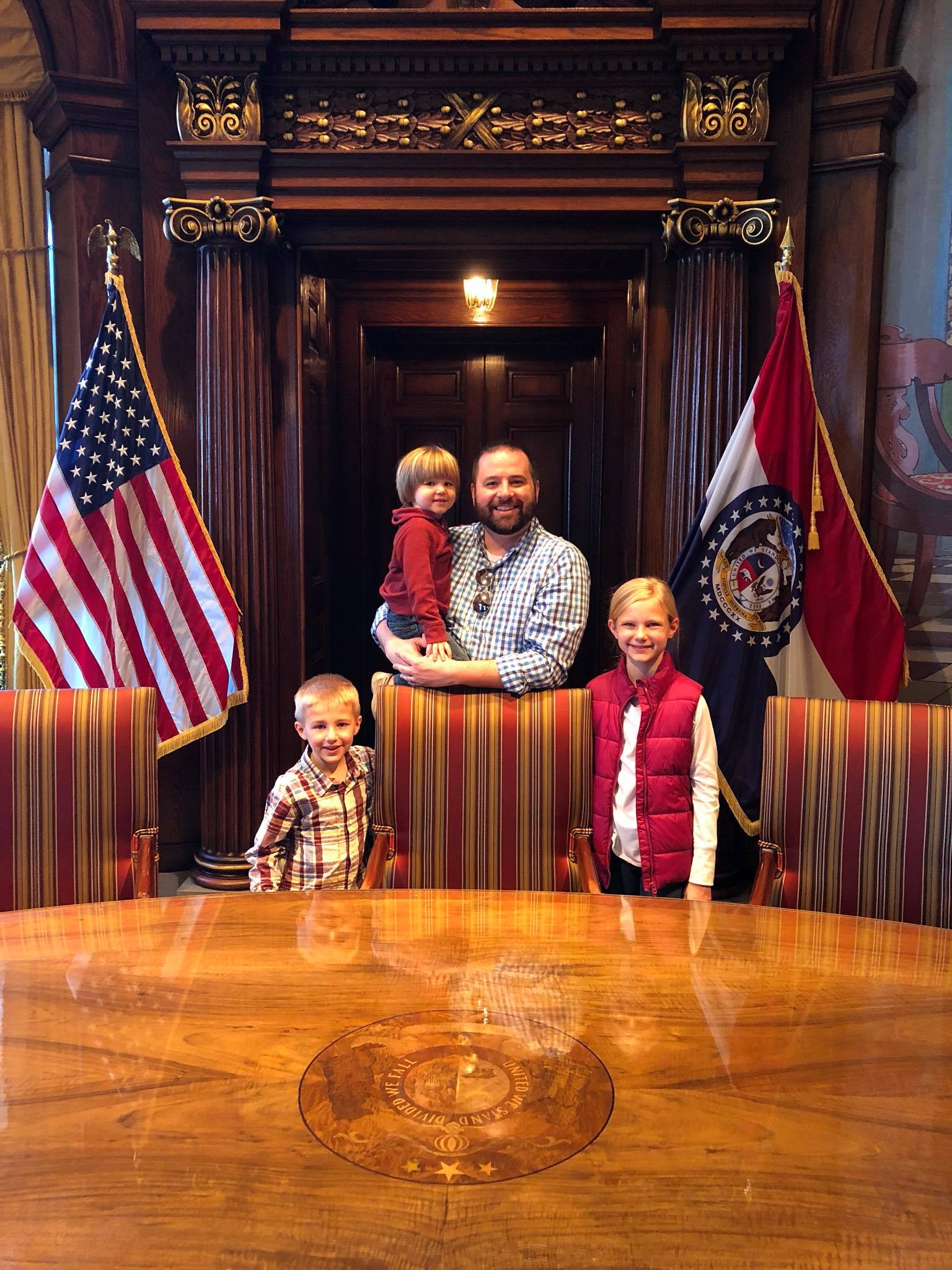 Michael and his three kids in the Missouri Governor's office.