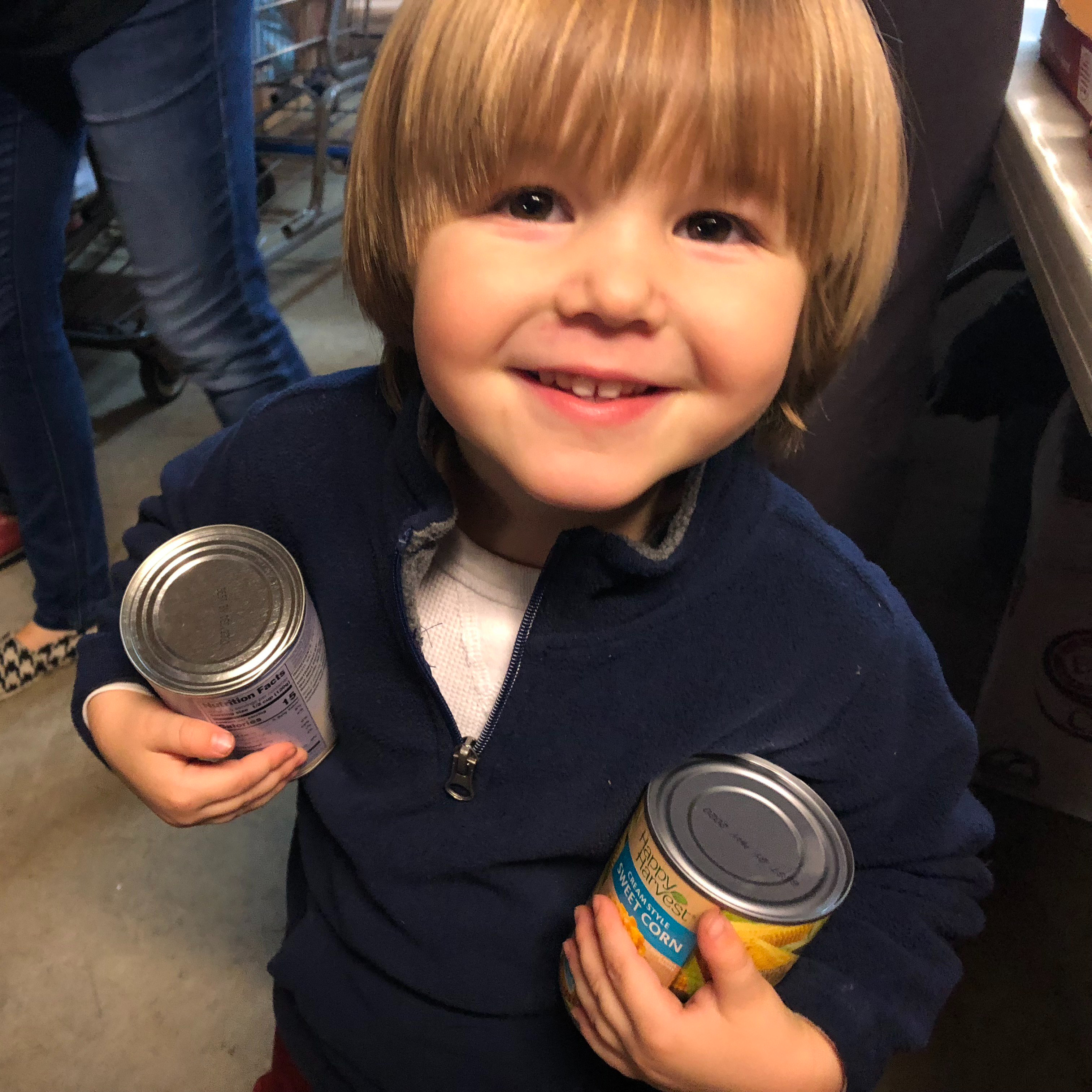 Our youngest son carrying cans in the church food pantry.