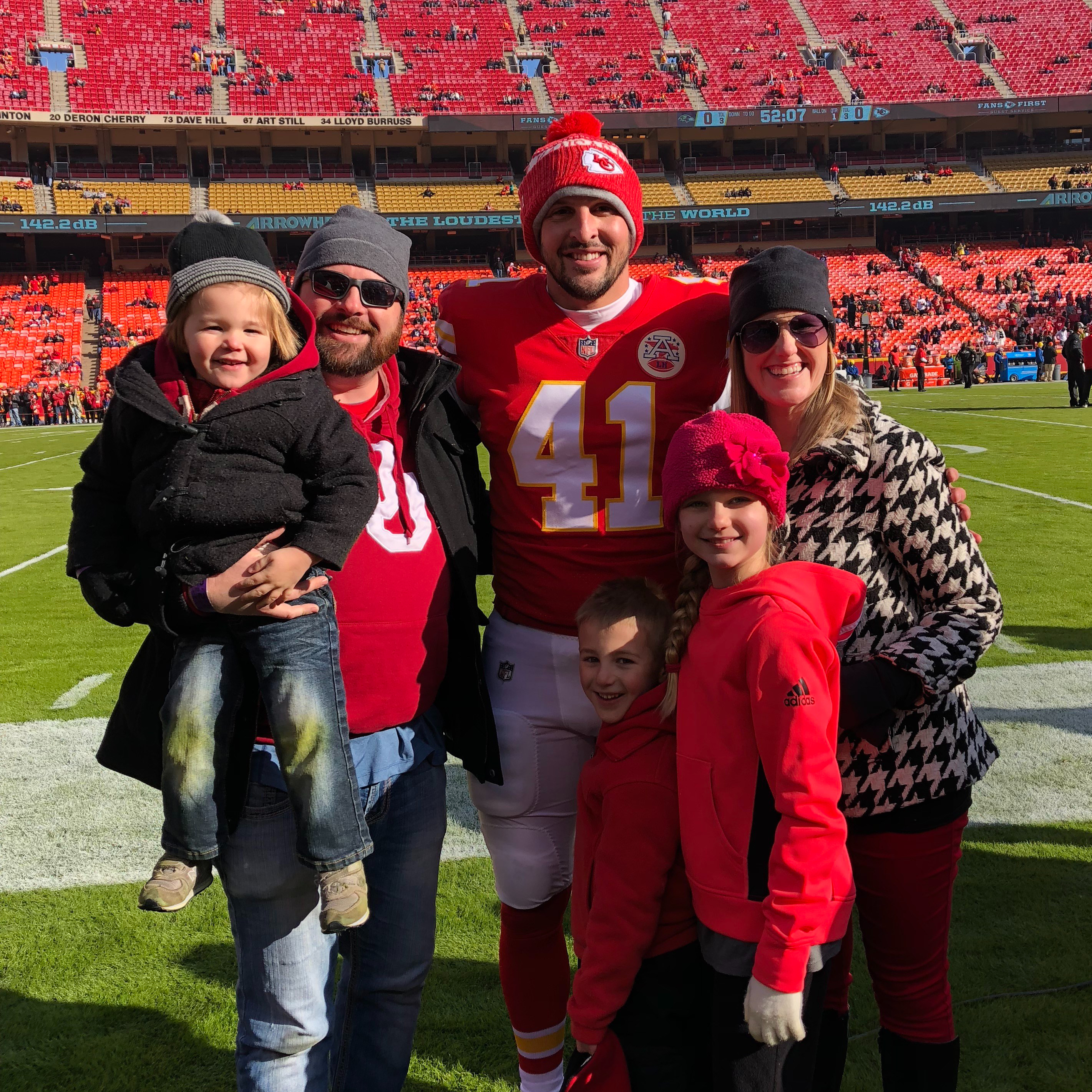 Michael and family with Kansas City Chiefs long snapper, James Winchester. Sidelines at Arrowhead Stadium in Kansas City.